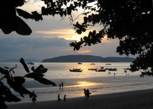 Local fishing families meandering by on a sunset stroll.